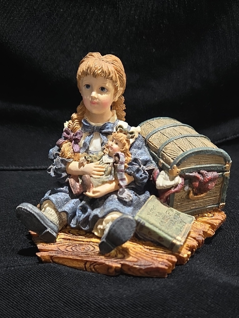 Hand-Painted Blue Girl Figurine with Doll and Treasure Chest